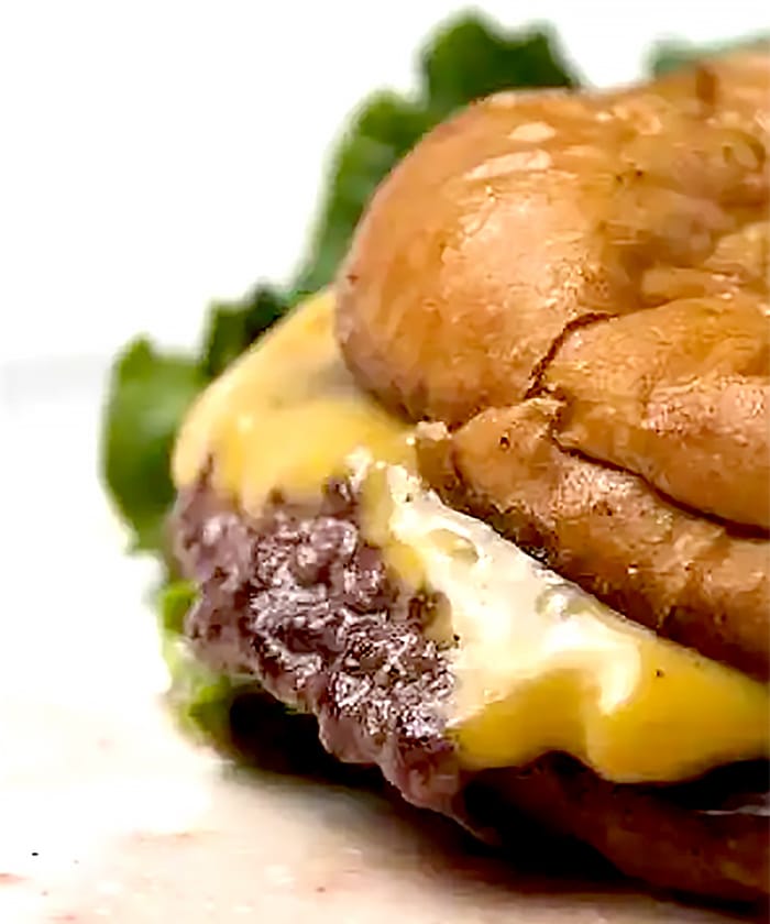 Hamburger with cheese on a bun.