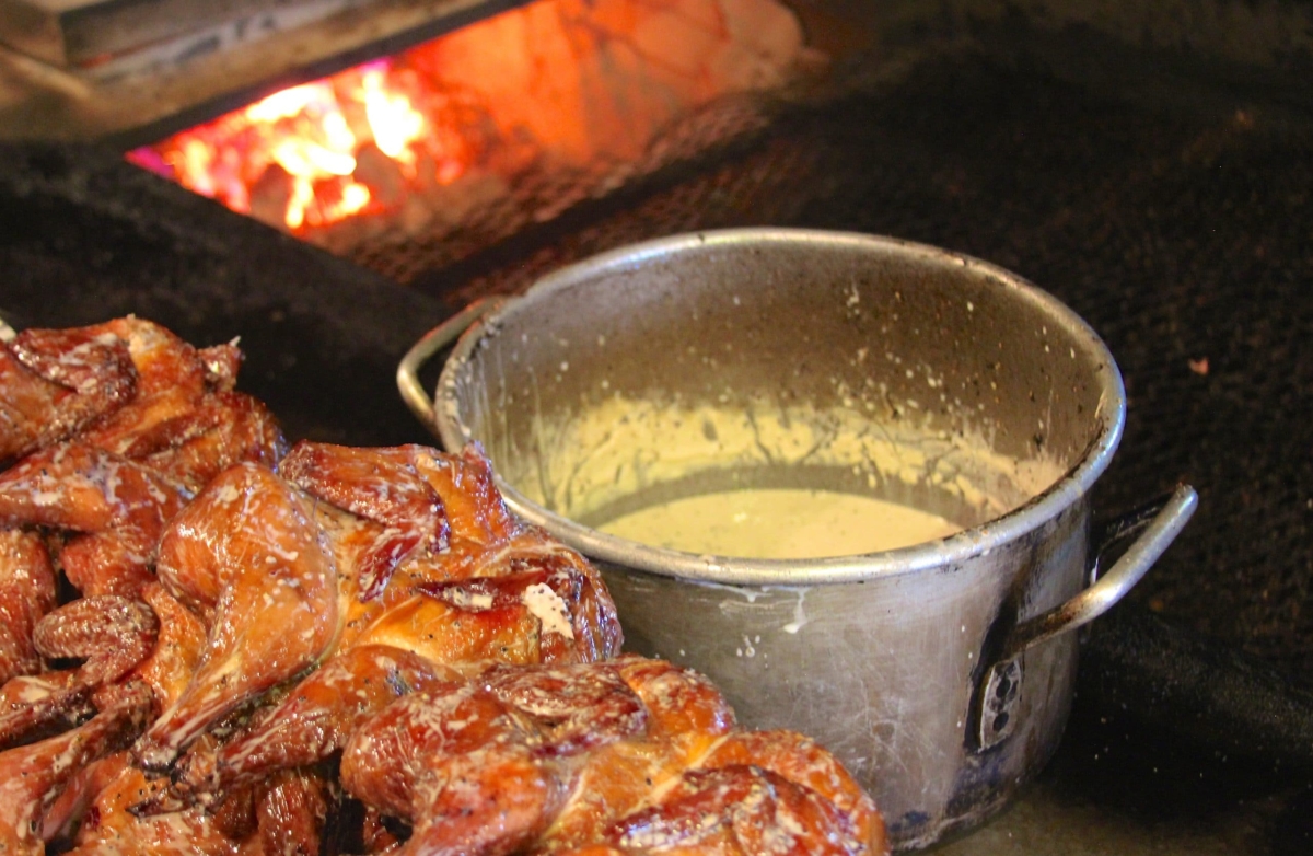 Chickens dunked in Alabama white BBQ sauce at Big Bob Gibsons