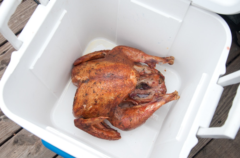 Cooler with a cooked turkey inside.