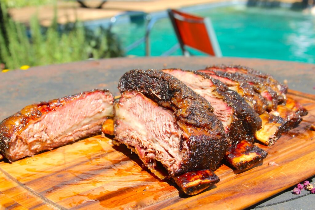 Sliced beef ribs on a cutting board.