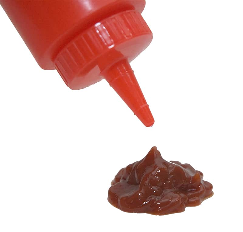 Close up of ketchup coming out of a bottle.
