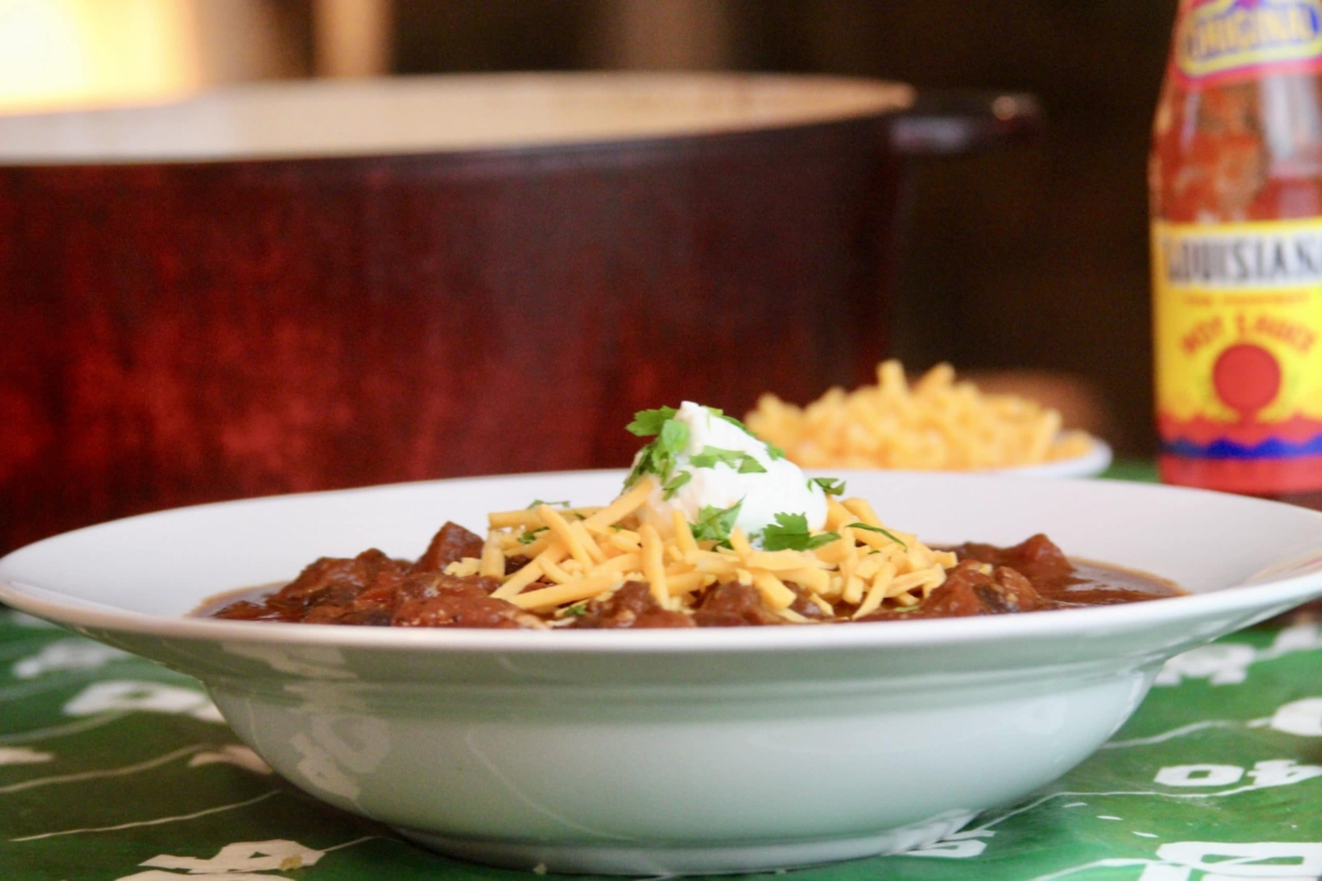 Chili con carne in a bowl with cheese and sour cream