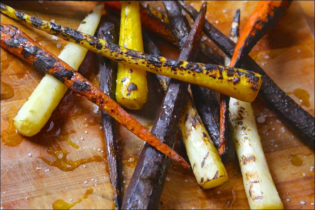 Charred carrots on a cutting board