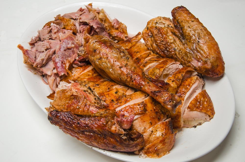 Carved turkey on a white platter.