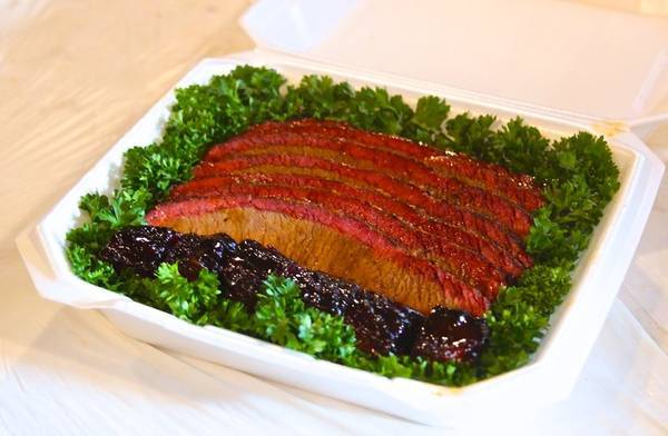 Sliced brisket and burnt ends in a competition BBQ turn-in box