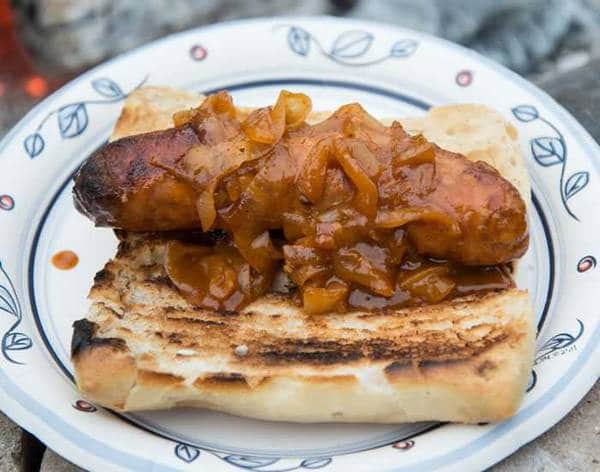 bratwurst on bun with caramelized onions