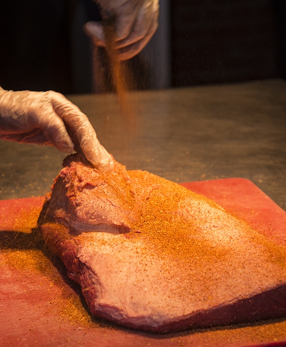 BBQ rub being sprinkled on to meat