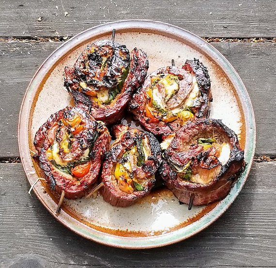Grilled Caprese salad stuffed flank steak pinwheels plated