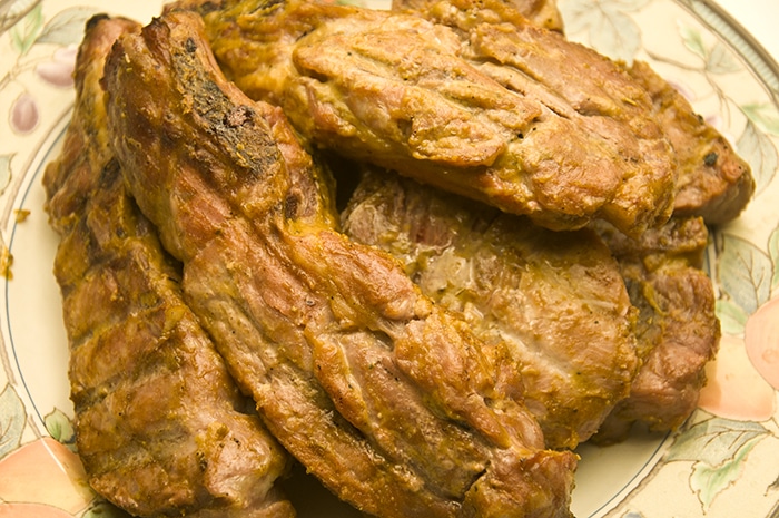 A plate of pork chops with mustard sauce