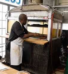 pitmaster using aquarium style pit at cozy corners barbecue