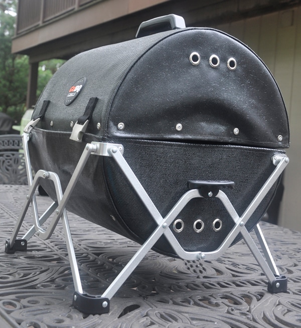 Black leathery cylindrical object mounted on a shiny, fold-out stand.