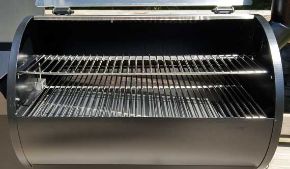 Shiny steel cooking grates in an outdoor cooker.