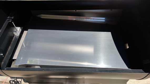 Shiny steel tray slanted at an angle.