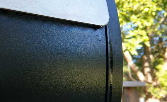 Dark gray barrel with grease dripping down the side.