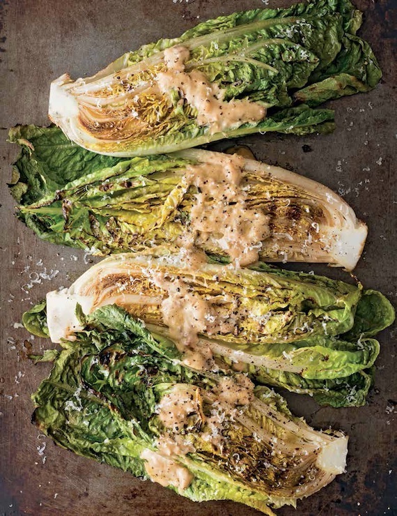 Grilled romain quarters sprinkled with Parmesan cheese