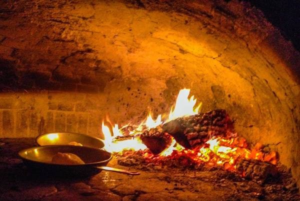 pizza oven with pans heating inside