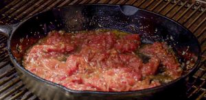 Heating tomato sauce in a skillet