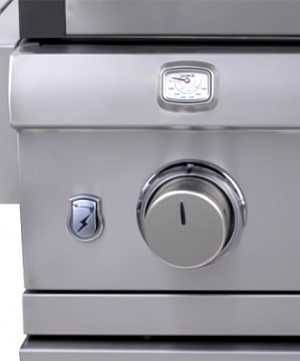 Close up of a shiny steel gas grill control knob with a thermometer positioned right above. 