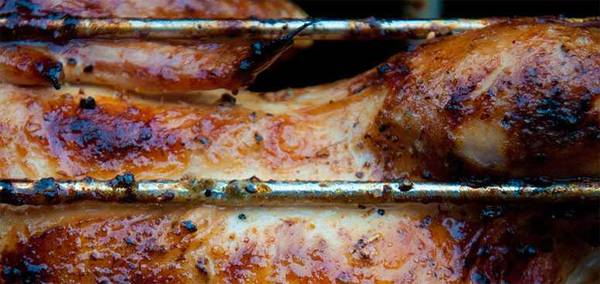 chicken roasting on a grill rack