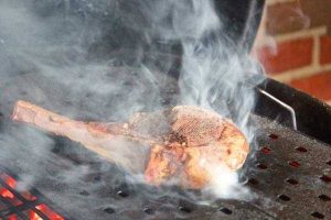 Searing a bison ribeye on the grill