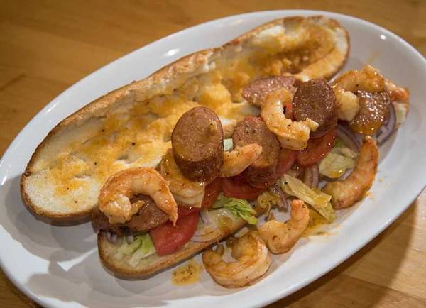 Po boy with lid off showing shrimp and andouille