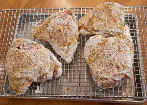 Dredged chicken on a cooling rack