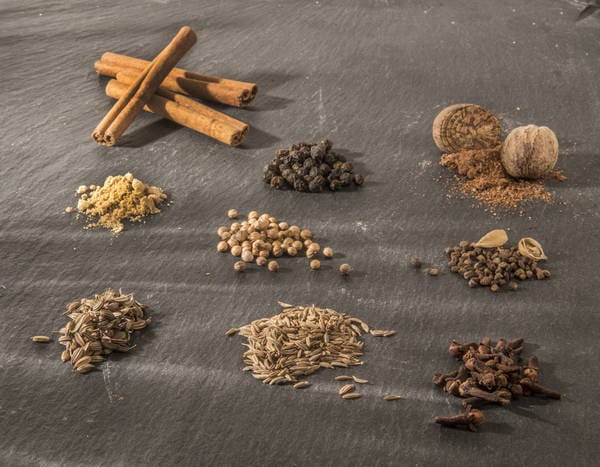 garam masala spices on a black board, waiting to be combined