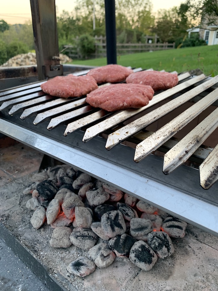 burgers over charcoal briquets
