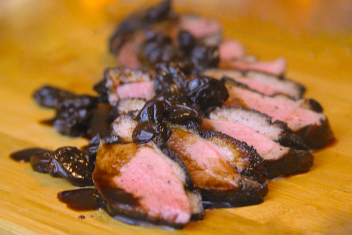 Sliced duck breast with balsamic-cherry sauce.