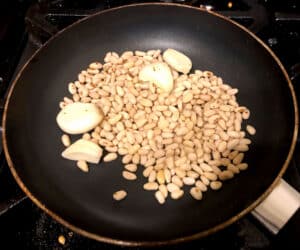 toasting pine nuts and garlic cloves.