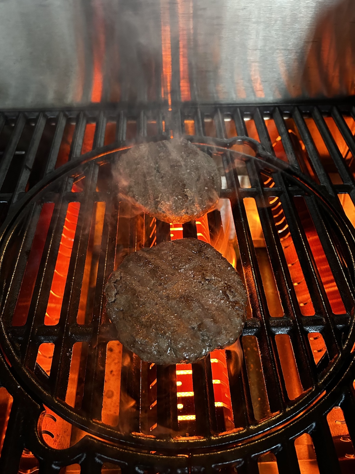 Steakhouse burgers searing on grill